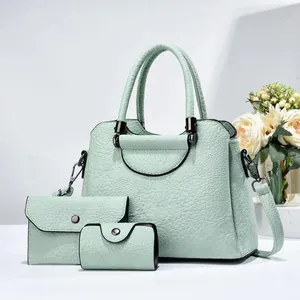 Three-piece mint green tote handbag set with matching wallet and card holder