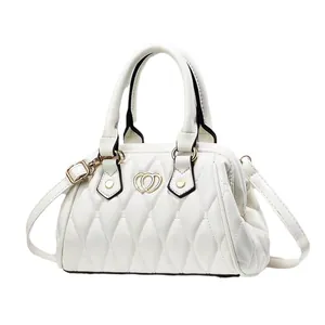 Bolso bandolera acolchado blanco con cierre de corazón dorado y asa superior