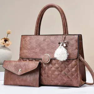 Brown quilted leather tote and clutch set with pearl fur ball charm and gold hardware