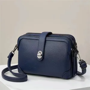 Dark blue litchi pattern leather crossbody bag with multiple zippers and silver buckle