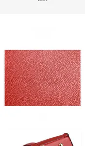 Close-up of red lychee pattern leather material and gold protective studs on handbag