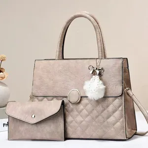 Elegant beige quilted tote bag set with metal buckle and pearl bow charm accessory
