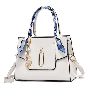 Cream textured leather handbag with silk scarf handle and pearl leaf pendant details