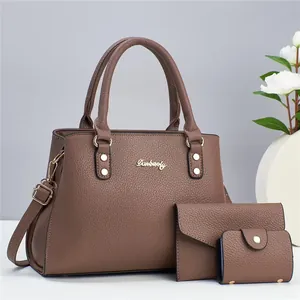 Three-piece brown litchi leather handbag set including a tote, wallet and coin purse