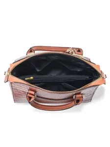 Internal view of brown crocodile pattern handbag showing zip pocket and black lining