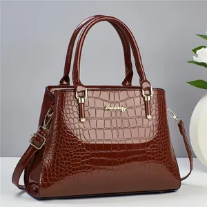 Elegant wine red crocodile pattern leather handbag with gold metal hardware and strap