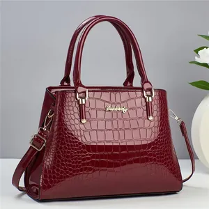 Elegant wine red crocodile embossed tote bag with gold hardware and top handles