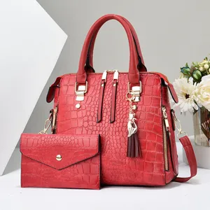 Women's red crocodile embossed tote bag and matching envelope pouch set with gold cat charm