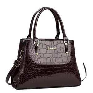 Polished dark brown crocodile pattern leather handbag with gold logo and dual handles