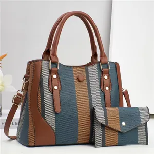 Détail du sac cabas rayé montrant la texture tissée et les rivets dorés