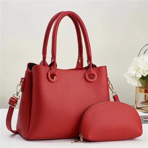 Minimalist red leather tote bag and zip pouch set with gold hardware and shoulder strap