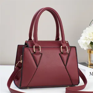 Elegant wine red textured leather tote bag with gold hardware and adjustable strap