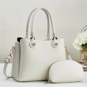 Close-up of off-white lychee texture tote bag set with golden hardware details