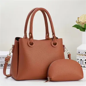 Detail of caramel lychee grain leather tote bag with matching semi-circular coin purse