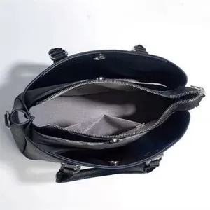 Interior view of large capacity black leather tote bag with multiple compartments