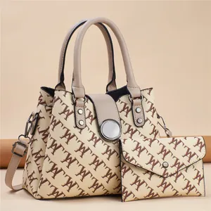 Detail of printed tote bag set with monogram pattern and adjustable shoulder strap