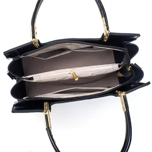 Interior view of black crocodile pattern tote bag with compartments and gold hardware