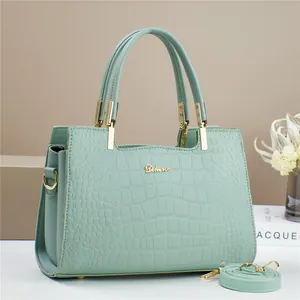 Light green crocodile pattern handbag with gold logo and detachable shoulder strap