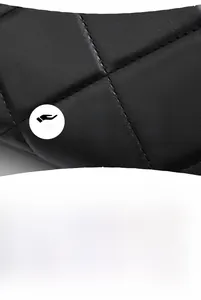 Macro shot of black quilted faux leather with smooth texture and soft sheen finish