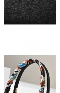 Dettaglio della trama in pelle nera e del foulard di seta avvolto sul manico della borsa