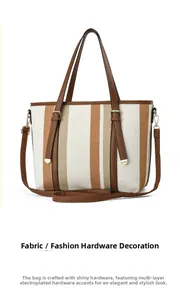 Detail of striped canvas tote with gold-plated hardware and brown leather handles