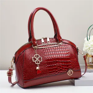 Fashionable red crocodile pattern patent leather handbag with clover charm and K logo