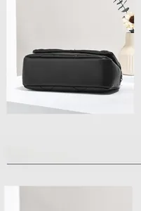 Close-up of quilted black leather handbag showing precise stitching and bottom detail