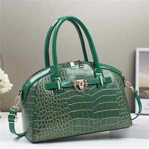 Borsa a mano verde scuro con goffratura a coccodrillo e dettagli in metallo dorato
