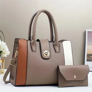 Detail of lychee pattern faux leather tote bag with elegant gold hardware and color block design