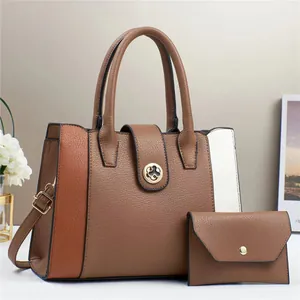 Detail view of contrast stitch tote bag with round floral lock and envelope wallet set