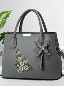 Elegant grey handbag with floral embroidery and butterfly charm for women