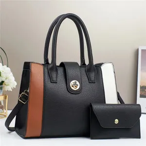 Detail of a two-piece fashion handbag set with color-blocking and golden flower clasp