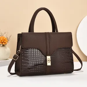 Detail of dark brown tote featuring crocodile, lychee and snake skin leather textures
