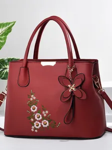 Deep red embroidered handbag for women with floral patterns and butterfly charm