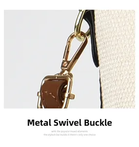 Macro view of a golden metal swivel clasp and brown leather strap on a textured bag