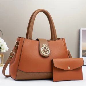 Dettaglio della borsa in pelle martellata arancio e marrone con pochette e fibbia dorata