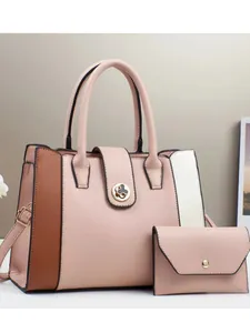 Pink faux leather handbag set with color-block sides and golden clover metal clasp
