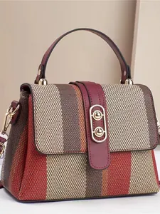 Retro Web-Handtasche in Kontrastfarben mit weinrotem Lederbesatz und Goldbeschlägen