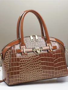 Brown crocodile embossed handbag with gold stud hardware and glossy finish