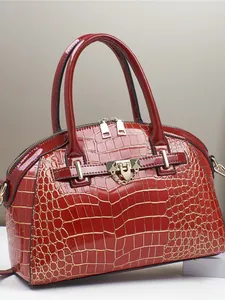 Polished red crocodile embossed tote bag with gold hardware and top handles