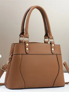 Brown textured leather handbag with dual handles and gold hardware for daily use