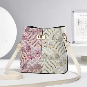 Detail of Chinese style bucket bag with colorful silk wave embroidery and gold clasp