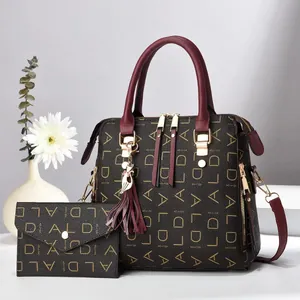Detail of printed tote bag set with matching wallet and cat charm on white surface