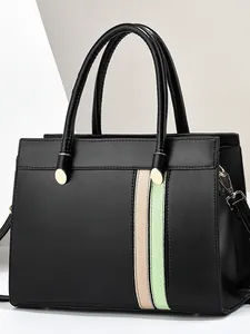 Black leather tote bag with pink and green stripes for stylish women commuting