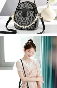 Detail of black mini crossbody bag with white geometric print and pearl handle chain