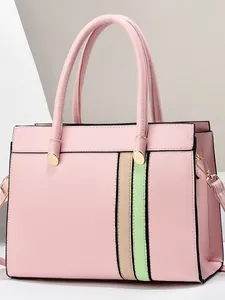 Pink faux leather tote bag with contrasting beige and green stripes and top handles