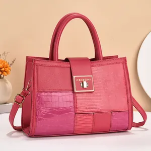 Macro view of textured rose and pink leather paneling with gold-toned metal clasp detail