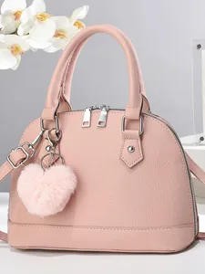 Pink shell handbag in textured leather with plush heart charm and detachable strap