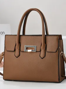 Classic dark brown pebble leather tote bag with gold metal clasp and detachable strap