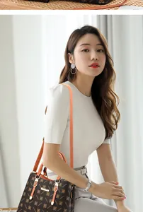 Detailed view of large contrast tote bag featuring POSIDIRI print and orange handles